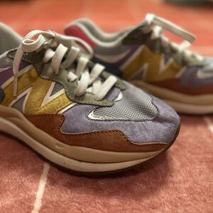 New Balance multicolor Women’s athletic sneakers in purple, yellow & brown